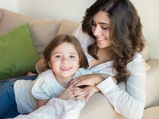 Mom and daughter playing on couch
